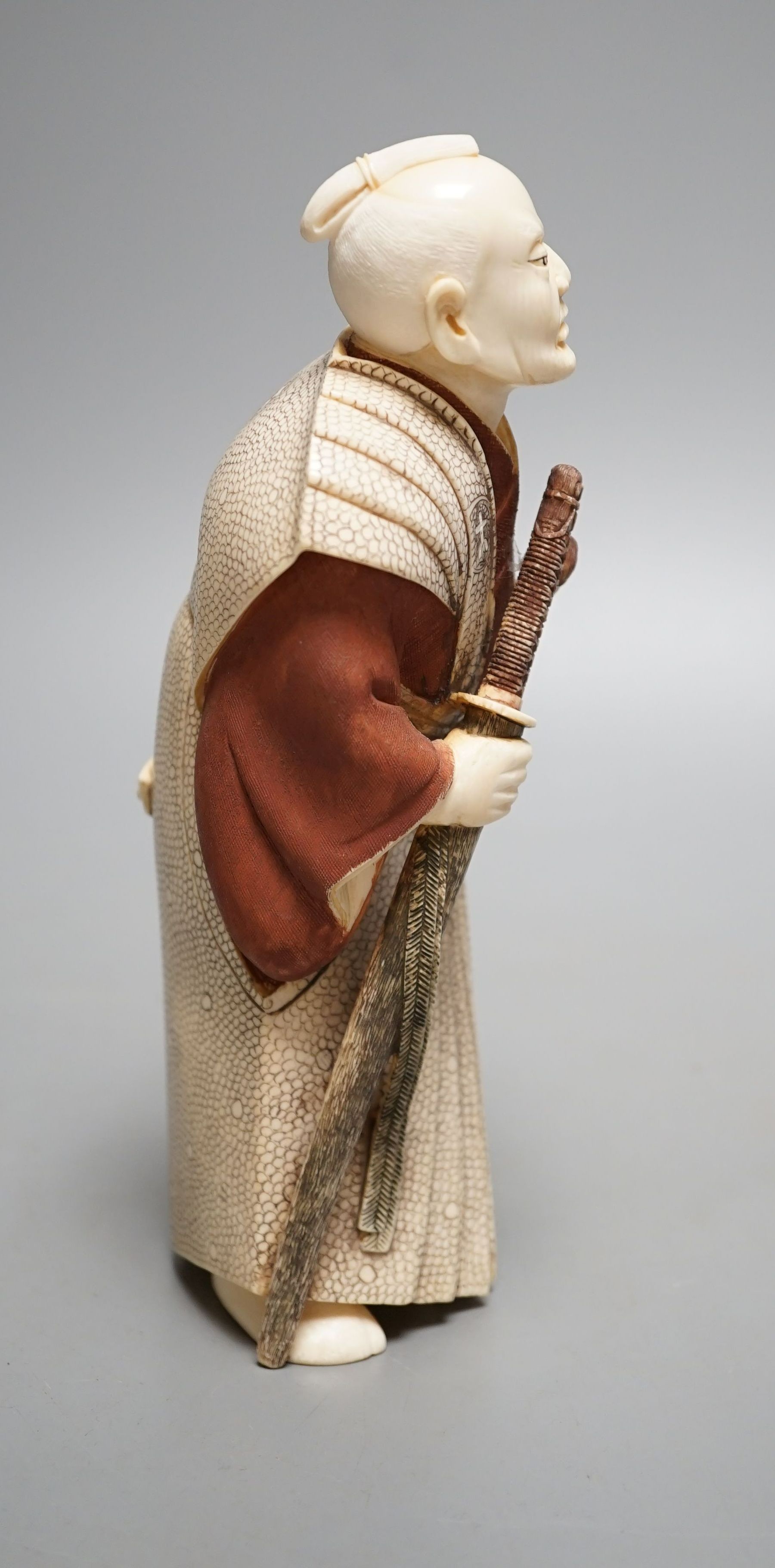 A Japanese ivory figure of a Samurai General, Taisho/early Showa period, signed to a lacquer tablet - 19.5cm tall